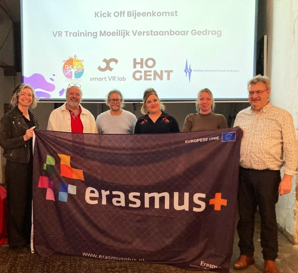 Project partners holding an Erasmus+ flag at the kick-off meeting